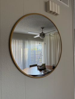 Round gold mirror