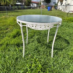 vintage Brown Jordan "Elegance" line oval patio table with a neoclassical design and rippled glass top
