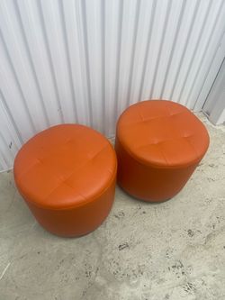 Pair of Orange Leather Round Ottomans