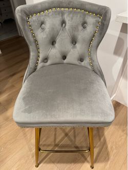 Velvet, grey with wooden legs and gold handle in the back