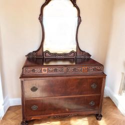 Antique dresser with ornate carvings and drawers