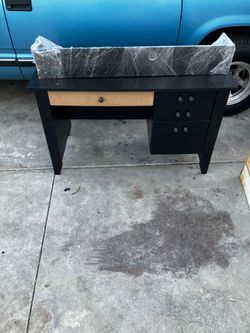 Black wooden desk with drawers