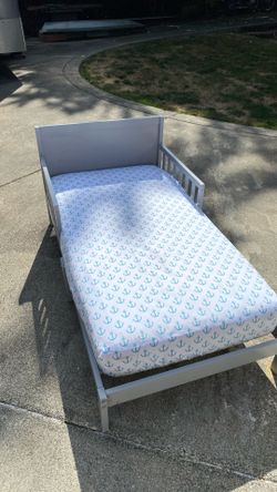 Toddler bed, crib size mattress.