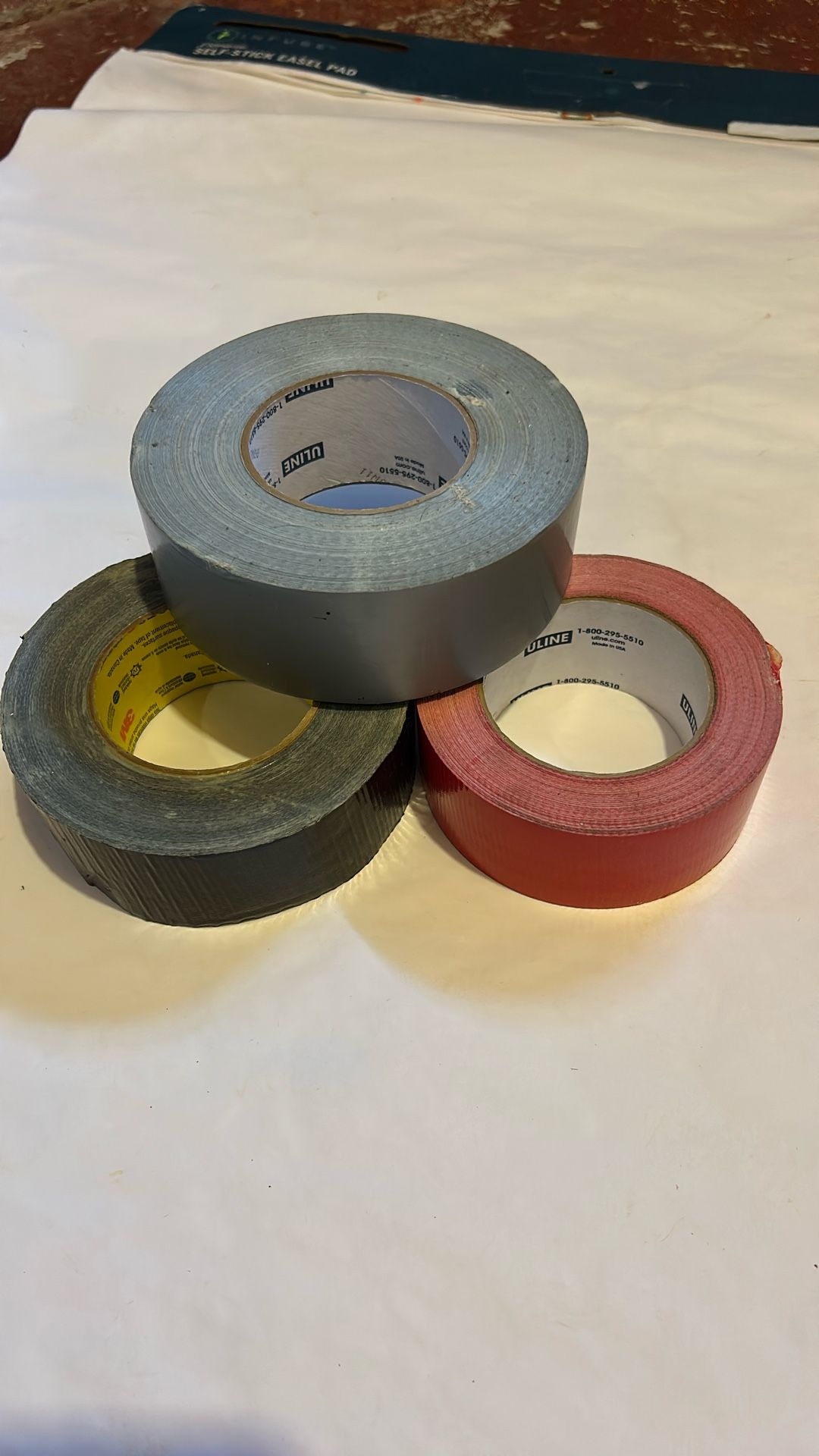 Black, Gray, And Red Duck Tape Rolls