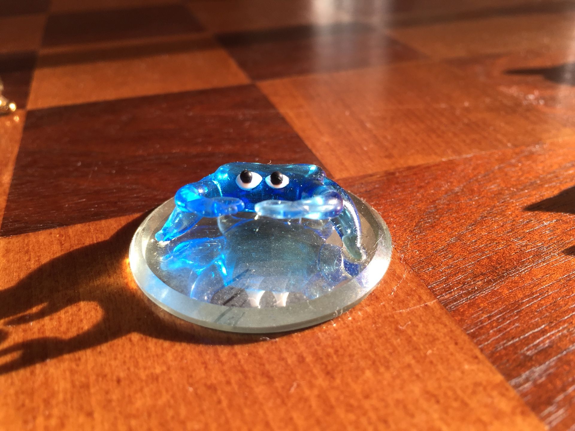 Blue glass crab on mirror display