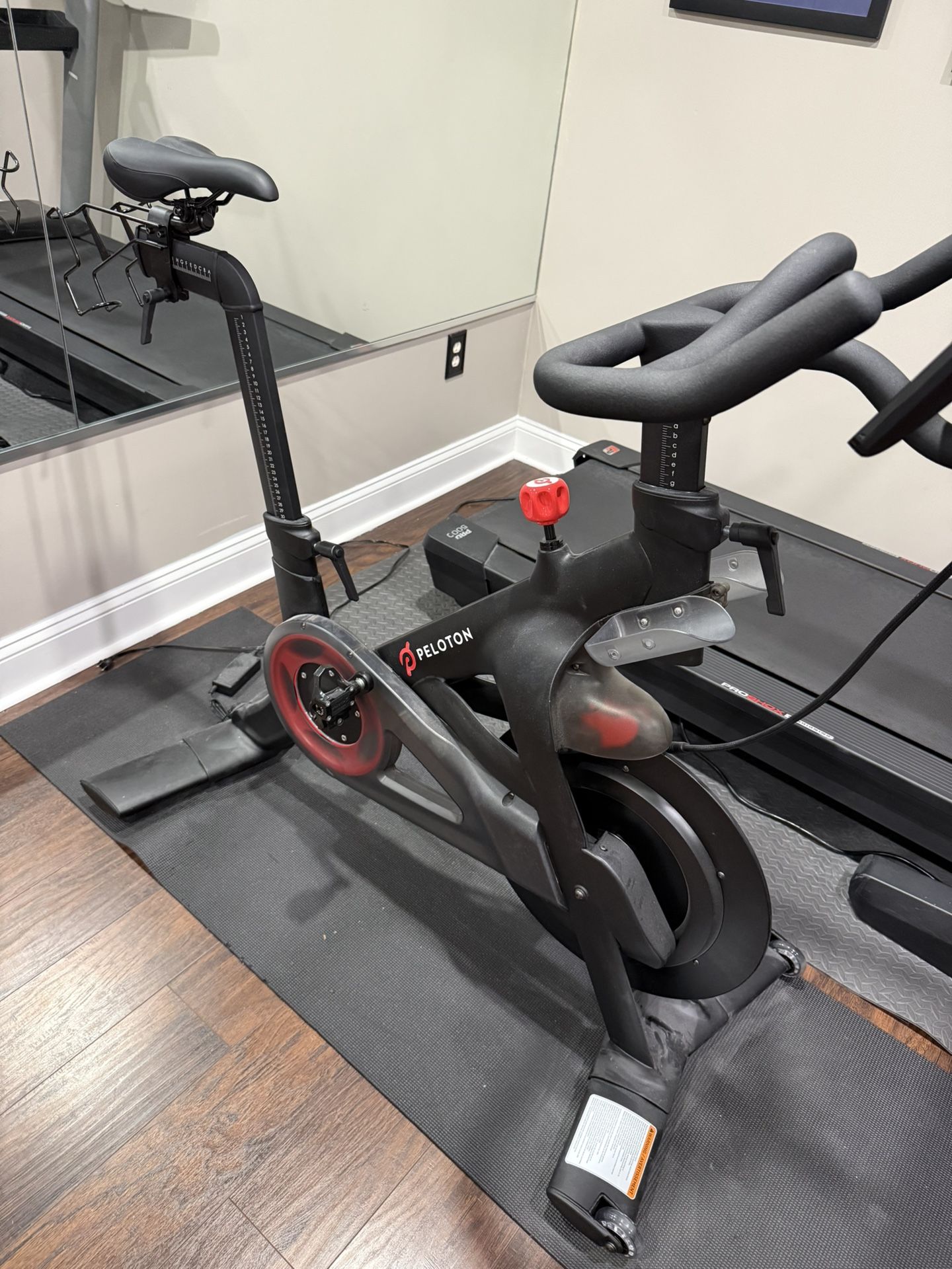 Peloton Exercise Bike With Multiple Pairs Of Shoes 