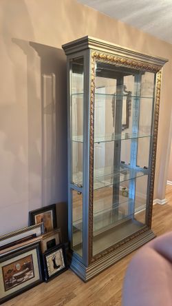 Vintage glass display case with ornate trim