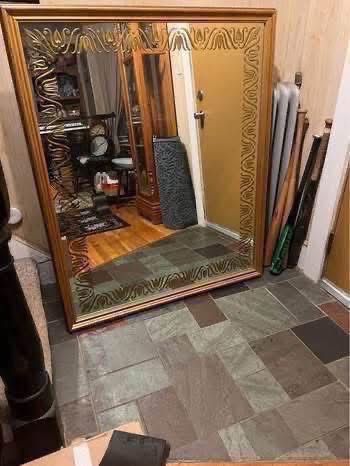 FREE Vintage 46x38 mirror set in a wood frame. Mirror has reverse etched and gold leaf painted design around the edges. Hooks on back, to be hung vert