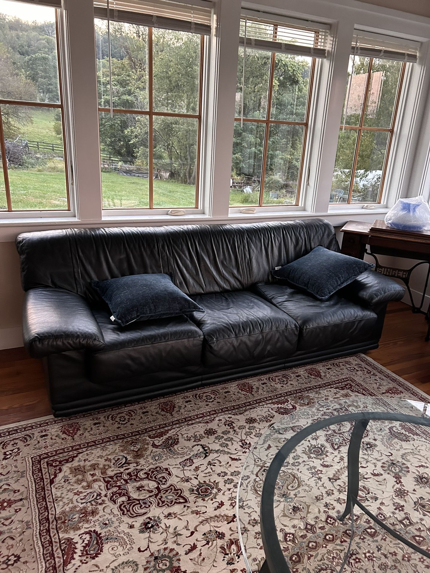 Black leather sofa, side chair with ottoman.