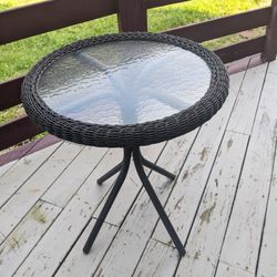 Beautiful Outdoor glass bistro table dark brown.
2 feet wide, 29 inches tall.
 Revere