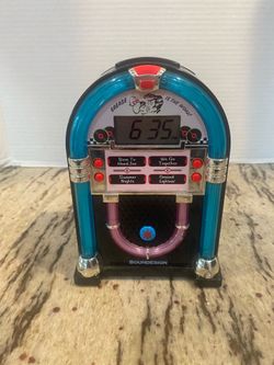 Soundesign retro-style "Grease is the Word" miniature jukebox alarm clock, model 3162G.