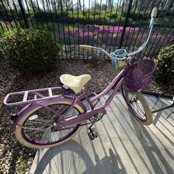 Pink beach cruiser bicycle in good condition.