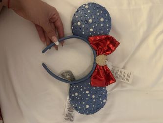 Disney's Snow White and the Seven Dwarfs, specifically celebrating its 85th anniversary.  The ears are adorned with colored gems and rhinestones, and 