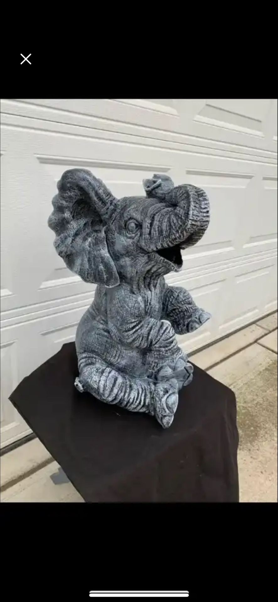 Large, happy elephant statue