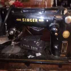 A Singer Sewing Machine With Pedal