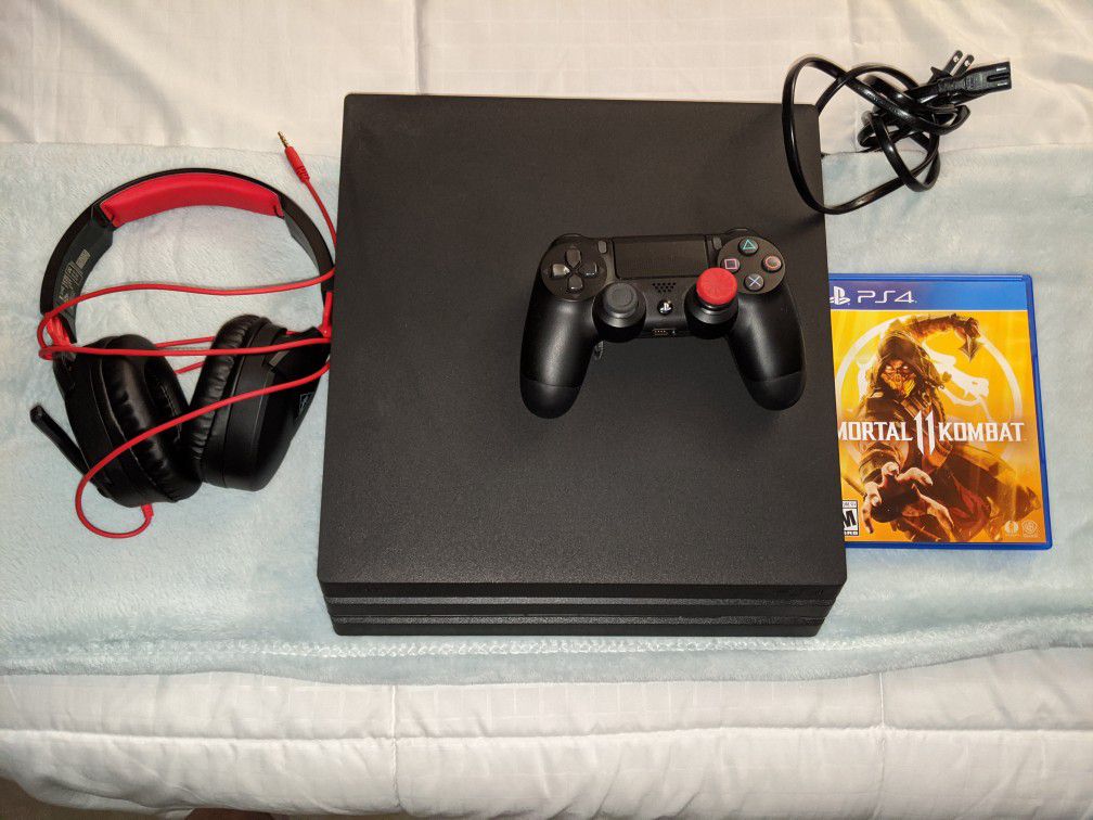 PS4 pro with Mortal Kombat 11 controller and headset