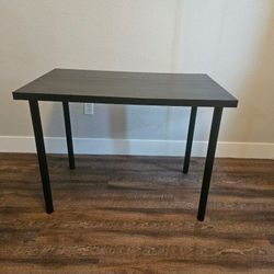 IKEA LINNMON tabletop with ADILS legs, forming a desk or table unit.