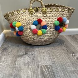 Straw Handbag With Multi Color Pom Pom’s 