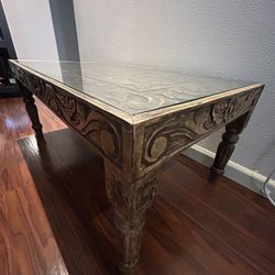 Hand carved coffee table with glass top