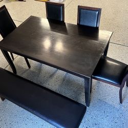 Dark Brown Table With Four Matching Chairs And A Bench