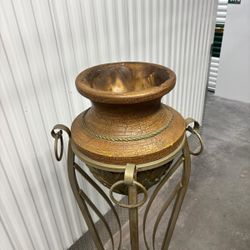 Hollywood Regency style wrought iron pedestal plant stand featuring a curvaceous Roman urn silhouette.   63” high , 15” round   $250