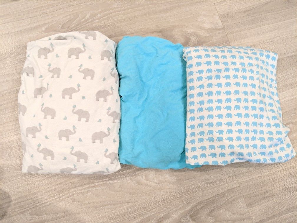 All nursery items. Elephants giraffes. Blue gray white. Sheets changing table covers crib mattress protectors blankets