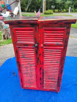 Asian style fold up storage shelfing unit on wheels.