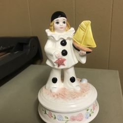 Schmid peirott love girl clown figurine holding yellow sailboat. Plays my favorite things from the sound of music. It turns when plays. But is slow