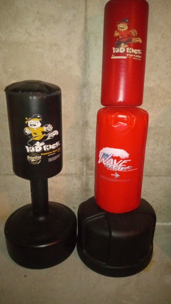 Two Heavy Duty Punching/Kicking Bags With Stand And An Extra Heavy Bag