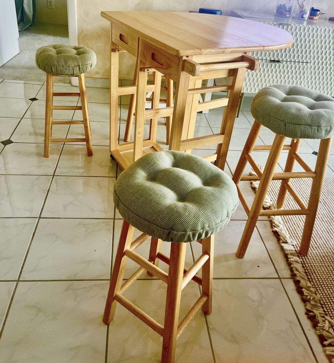  Extendable wooden table with two storage drawers. Comes with 4 upholstered stools