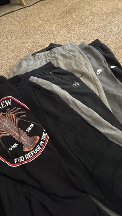 Bag of men’s sweats, and shirts and shirts.