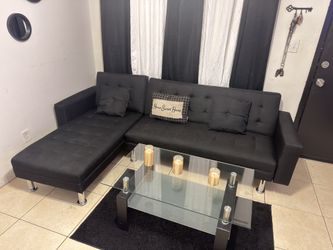 Black L-style futon sectional sofa with chrome legs"