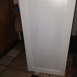 A Brand New Faucet And White Shaker Cabinet For A Bathroom