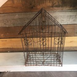 Bird cage with swinging heart