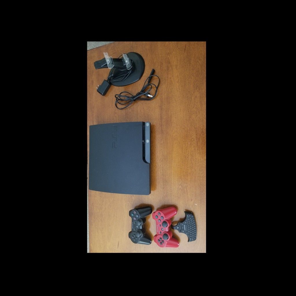 PS3 slim w/2 controllers/accessories/9 games