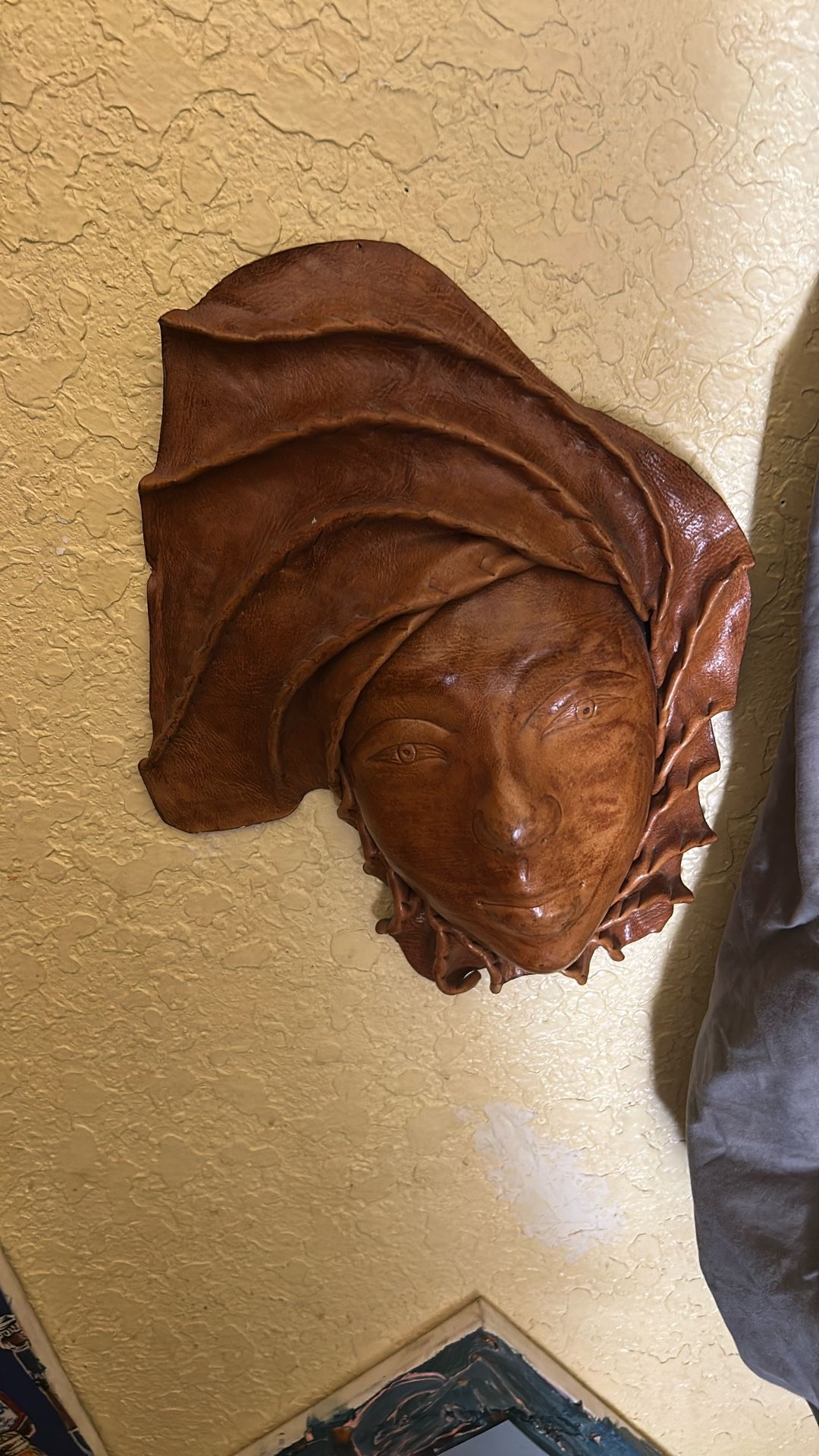 Leather face hangs on wall