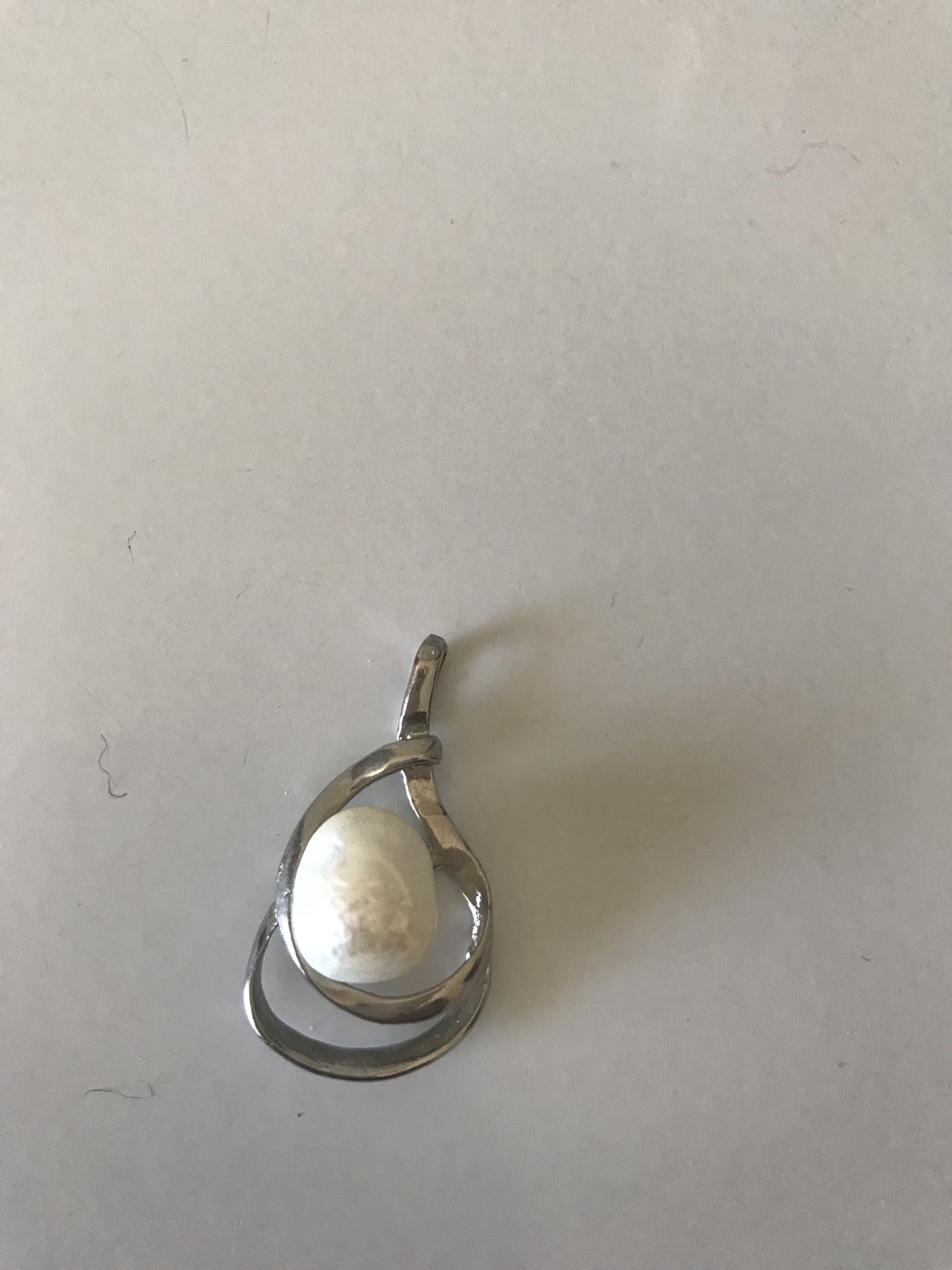 Silver and pearl charm