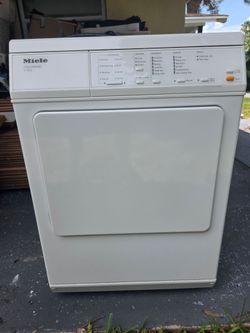 Miele Touchtronic T1413 electric dryer featuring a white finish and a stainless steel honeycomb drum.