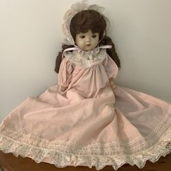 VINTAGE PORCELAIN BABYDOLL WITH BEAUTIFUL PINK DRESS & LONG DARK HAIR 