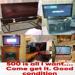 Samsung TVS (1)-50 INCHES AND (2) 40 INCHES WITH STAND AND Fire Place That's Electric. .