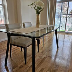 3ft x 5ft glass table with 4 leather chairs. Amisco brand  
