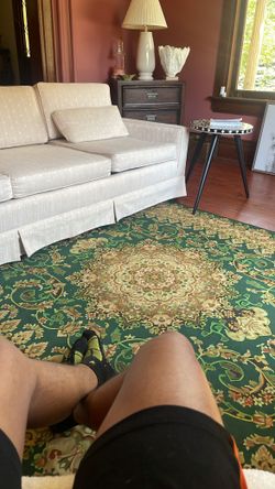Green rug off white Sofa 