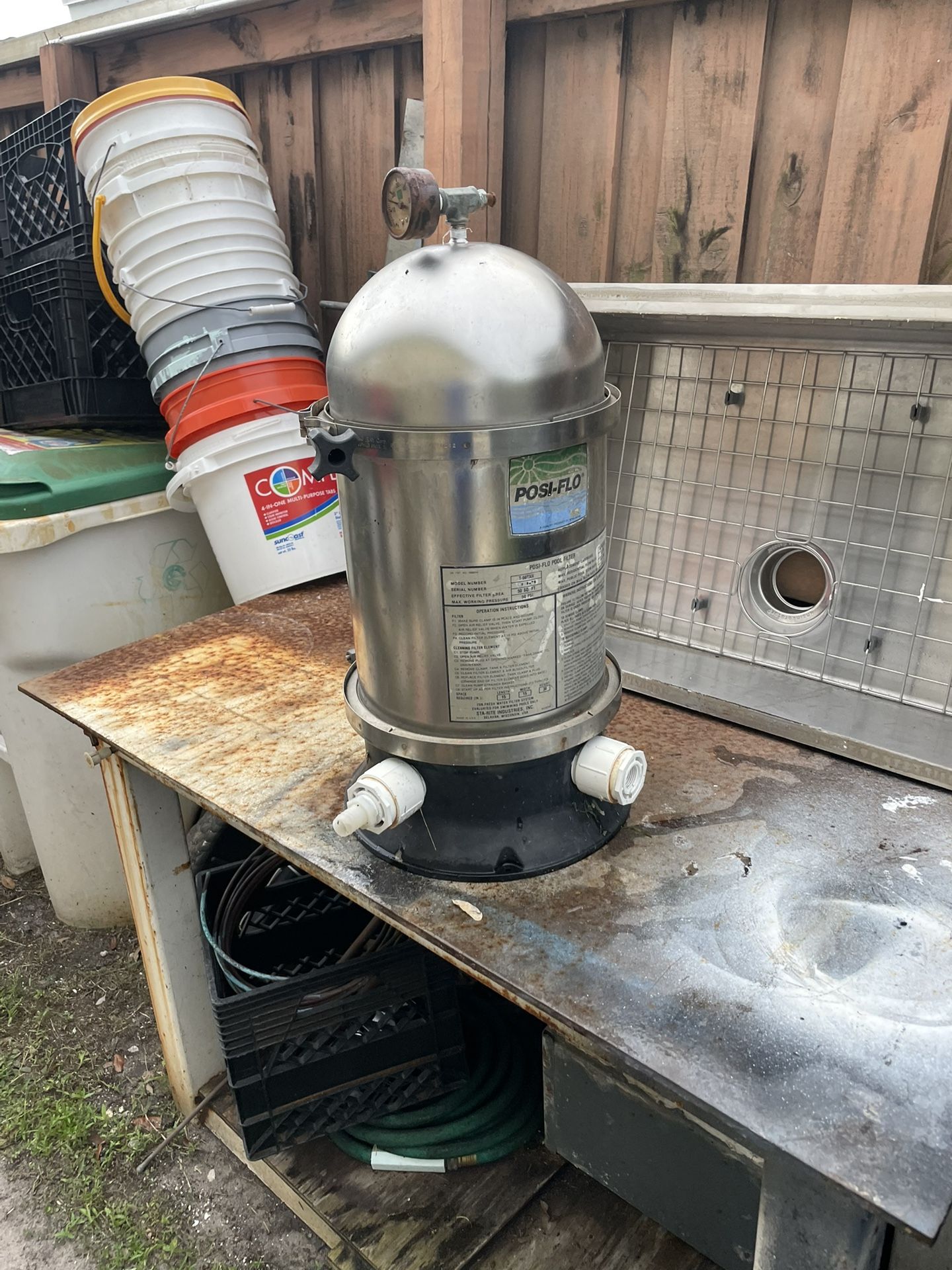 Swimming pool filter container system has filter in it, but needs to be cleaned