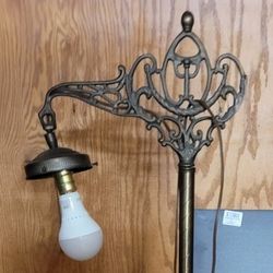 antique cast iron bridge arm floor lamp with glass shade.