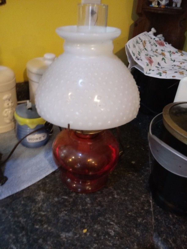 Vintage red oil lamp with white milk glass hobnail top