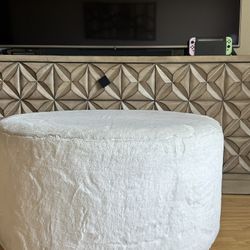 White Plush Ottoman With Gold Trim On The Bottom