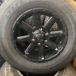 Bridgestone Dueler H/T 245/75R17 112T 685 A/S tires with black Ultra motorsports rims 