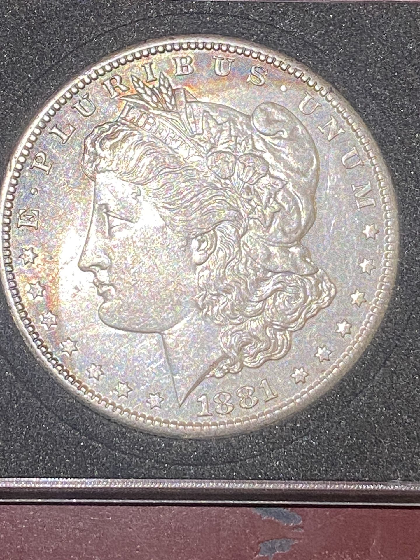 1881/s Silver Morgan With His A Slight Rainbow Monogram Crescent Tone On Front