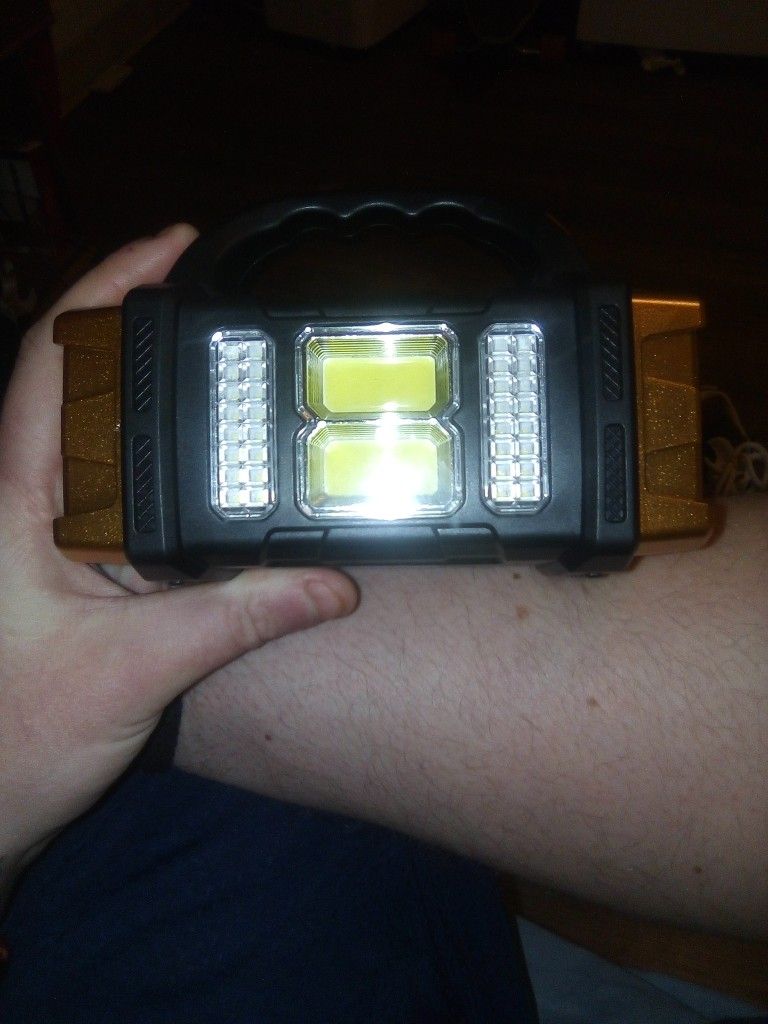 Flash Light With 4 Light Settings And A Solar Panel Phone Charger.