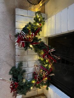 8 ft lighted garland with red/gold bows